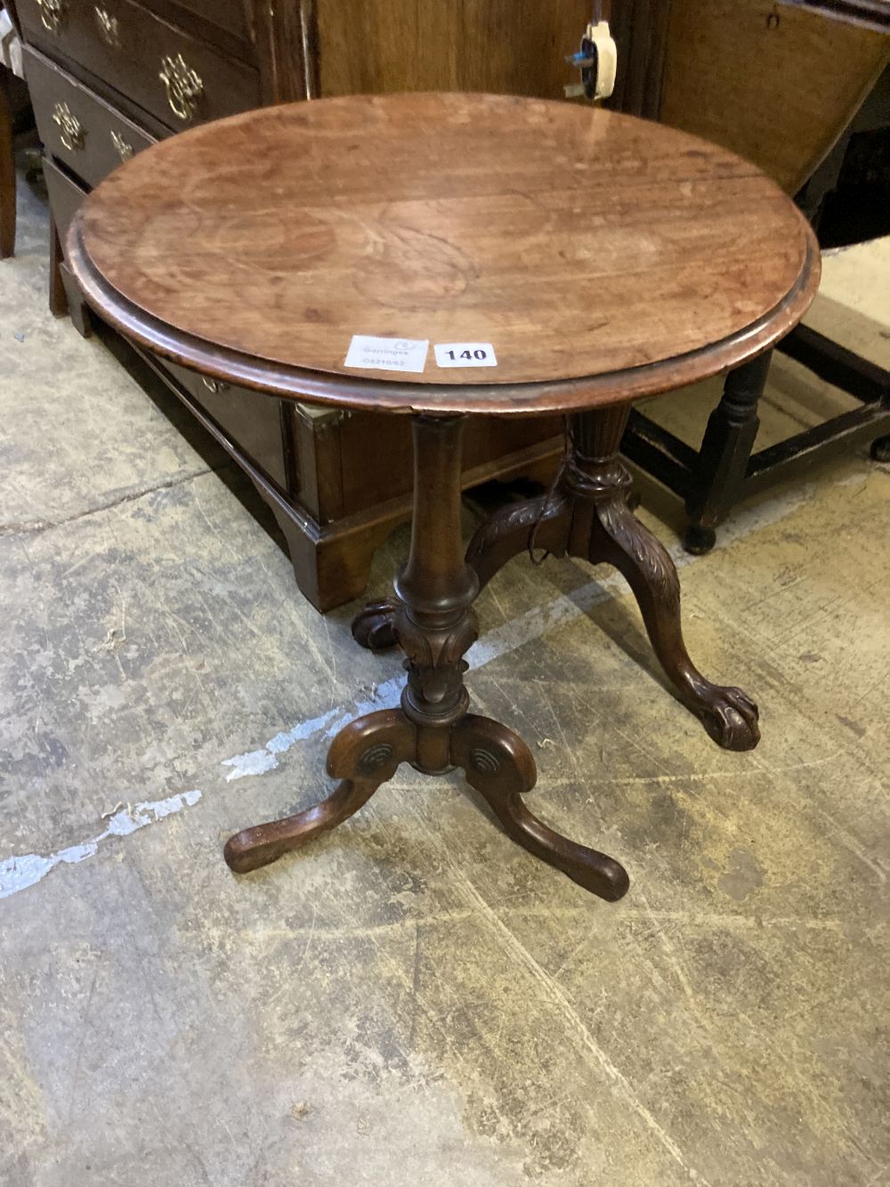 A Victorian mahogany tripod wine table, diameter 50cm height 70cm, together with a carved standard lamp